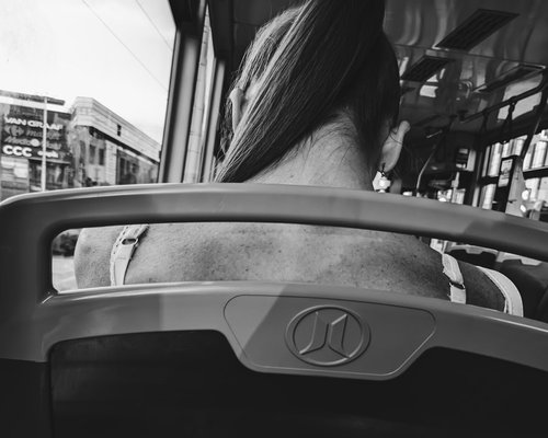 A relaxed public transportation passenger showing ideal spinal alignment while commuting
