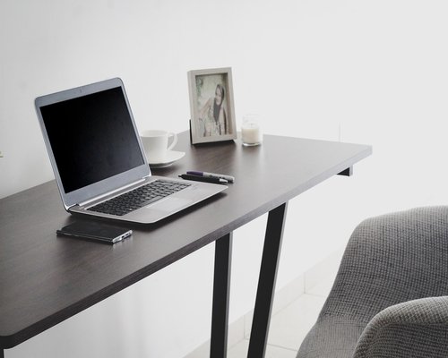 A professional worker standing up from an office chair intentionally